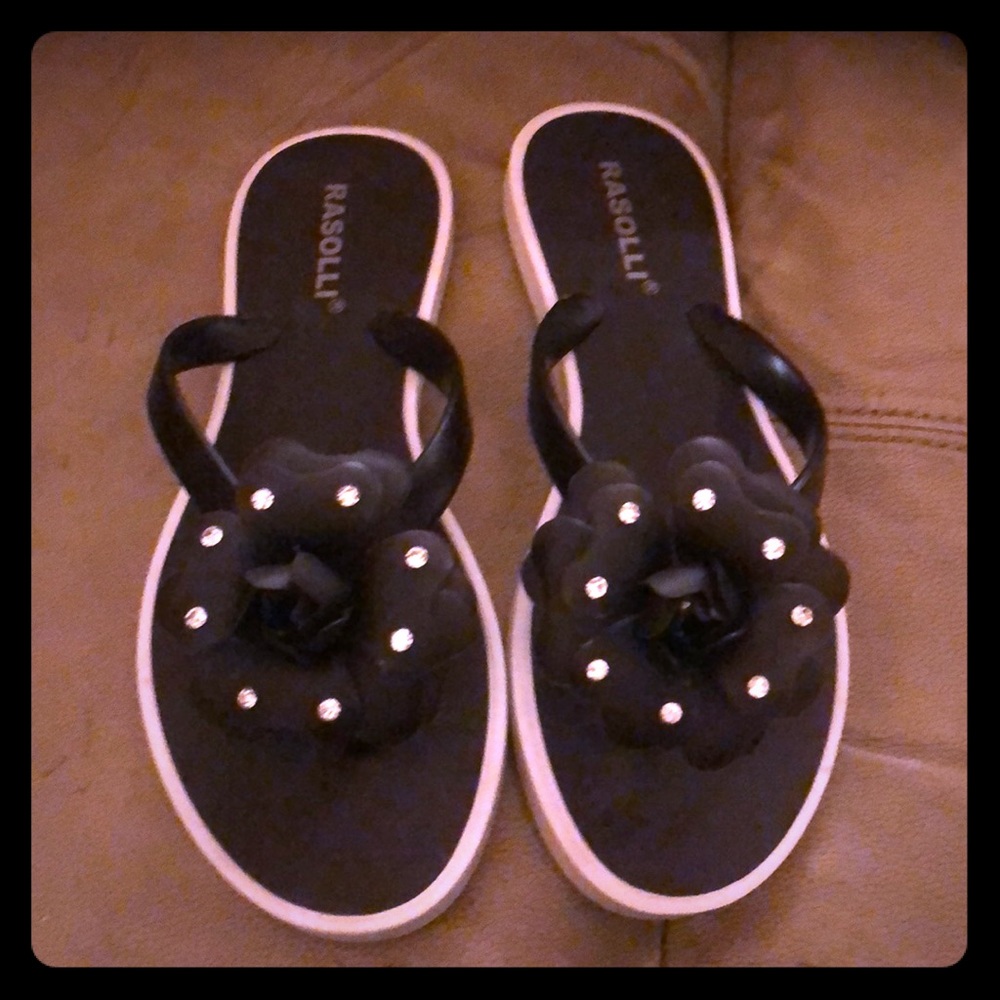 Bedazzled black rosette flip-flops